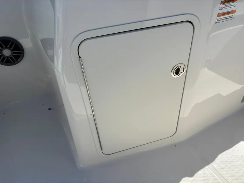 Slide: The Image of Storage compartment door on a 2024 Sea Ray SPX 210 Outboard boat. - 27