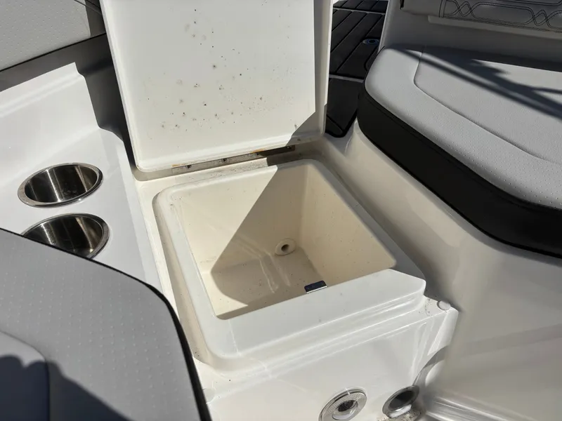 Slide: The Image of 2024 Sea Ray SPX 210 Outboard boat with open storage compartment. - 32