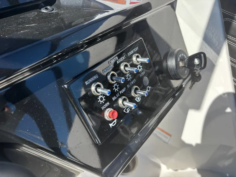 Slide: The Image of Control panel of 2024 Sea Ray SPX 210 Outboard with toggle switches. - 40