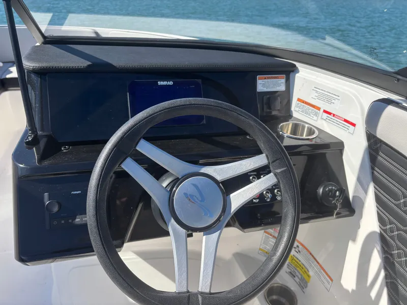 Slide: The Image of Steering wheel of 2024 Sea Ray SPX 210 Outboard on water. - 42