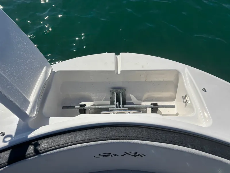 Slide: The Image of 2024 Sea Ray SPX 210 Outboard anchor compartment by the water. - 9