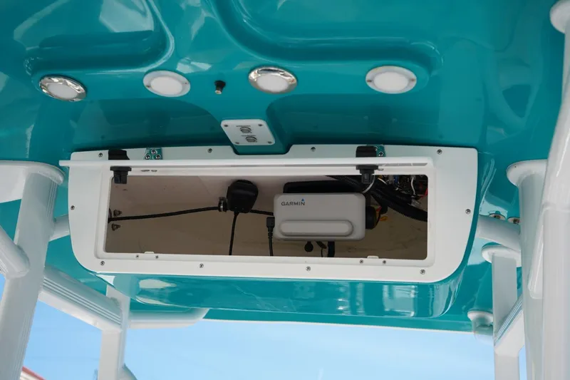 Slide: The Image of 2021 Sea Hunt Ultra 219 boat electronics compartment with Garmin device. - 11