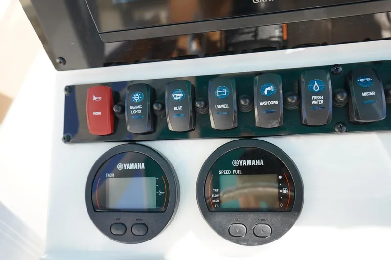 Slide: The Image of Control panel of 2021 Sea Hunt Ultra 219 boat with Yamaha gauges and switches. - 13