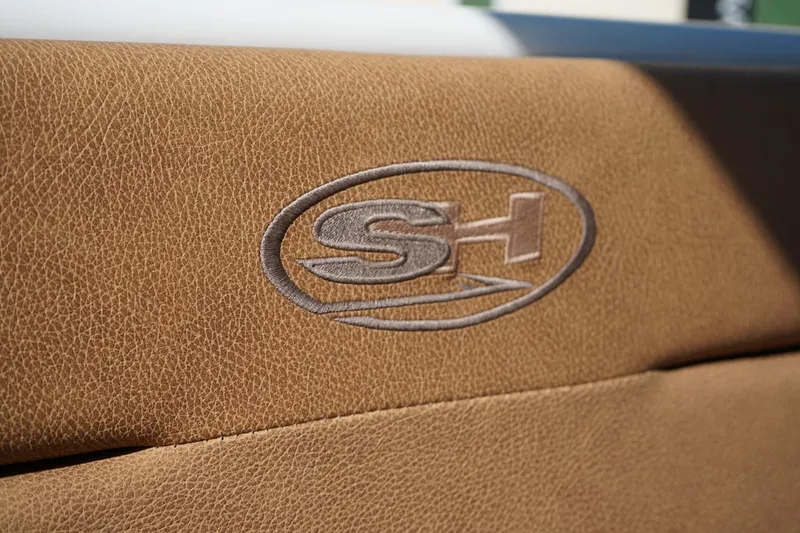 Slide: The Image of 2021 Sea Hunt Ultra 219 logo on tan leather upholstery. - 16