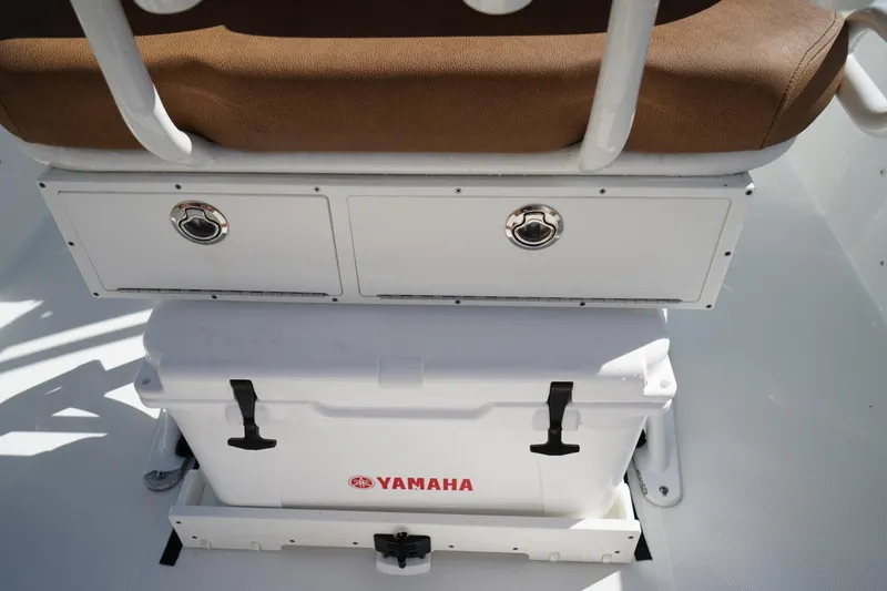 Slide: The Image of 2021 Sea Hunt Ultra 219 boat interior with Yamaha cooler and storage compartments. - 18