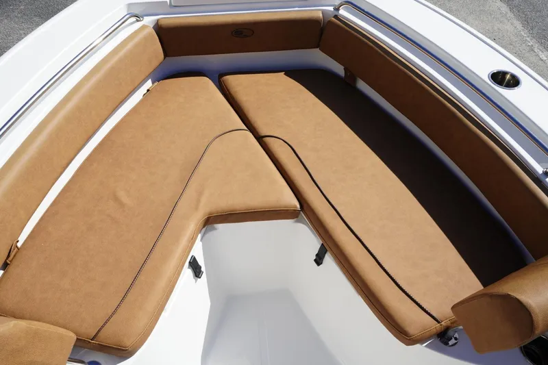 Slide: The Image of 2021 Sea Hunt Ultra 219 boat with tan cushioned seating in the bow area. - 21