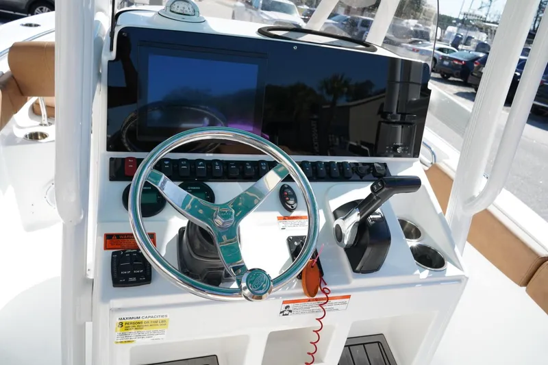 Slide: The Image of 2021 Sea Hunt Ultra 219 boat dashboard with steering wheel and control panel. - 32