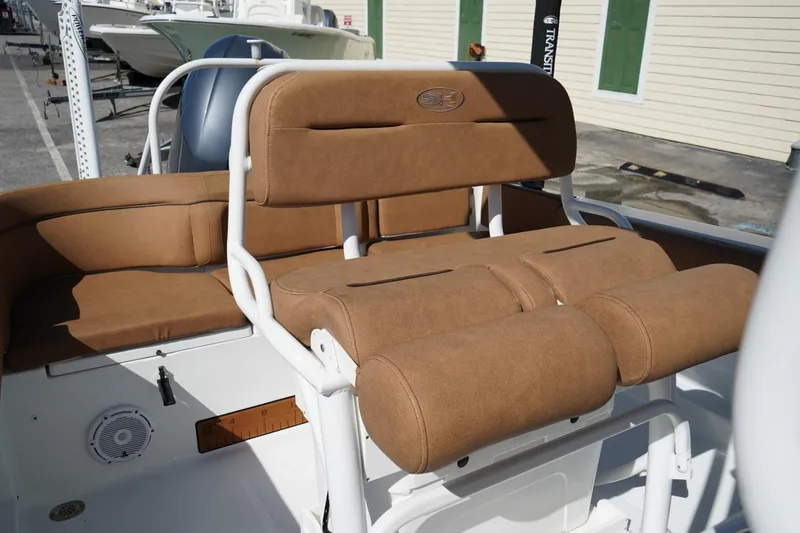 Slide: The Image of 2021 Sea Hunt Ultra 219 boat with tan cushioned seating and white frame. - 37