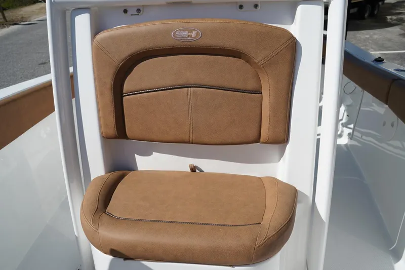 Slide: The Image of 2021 Sea Hunt Ultra 219 boat seat with tan upholstery and logo detail. - 43