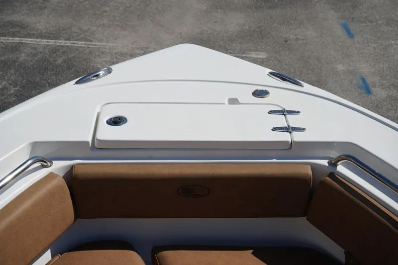 Slide: The Image of 2021 Sea Hunt Ultra 219 boat bow with cushioned seating and storage compartment. - 45