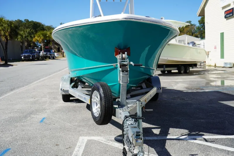 Slide: The Image of 2021 Sea Hunt Ultra 219 boat on trailer, parked outdoors. - 48