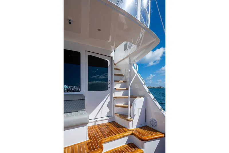 Slide: The Image of 2026 Viking 54 Convertible yacht with teak steps and ocean view. - 10