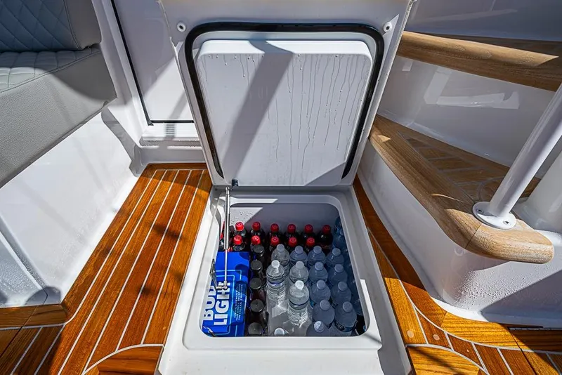 Slide: The Image of Built-in cooler on 2026 Viking 54 Convertible yacht, stocked with drinks. - 12