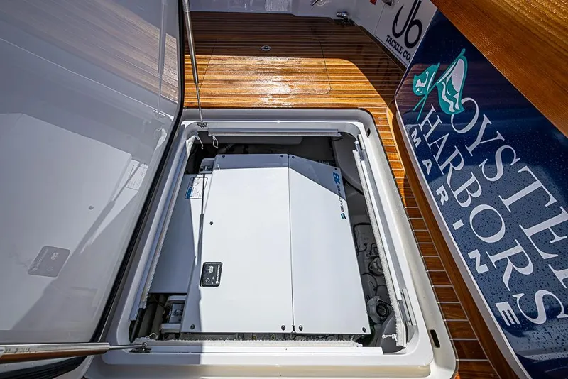 Slide: The Image of Engine compartment of 2026 Viking 54 Convertible yacht, featuring Oyster Harbors Marine branding. - 13