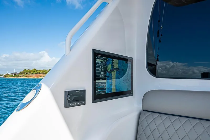 Slide: The Image of Interior of 2026 Viking 54 Convertible yacht with navigation display and ocean view. - 15