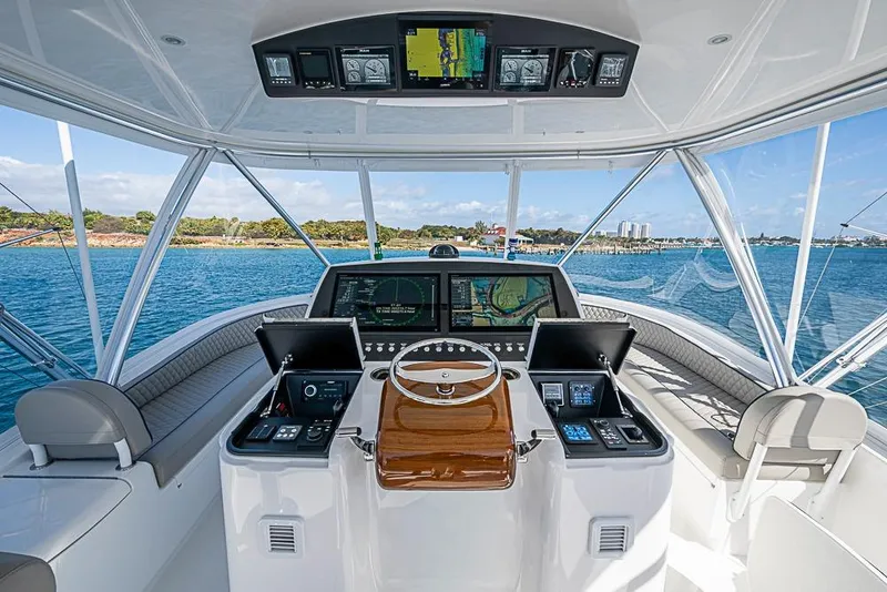 Slide: The Image of Helm of 2026 Viking 54 Convertible yacht with advanced navigation systems. - 16