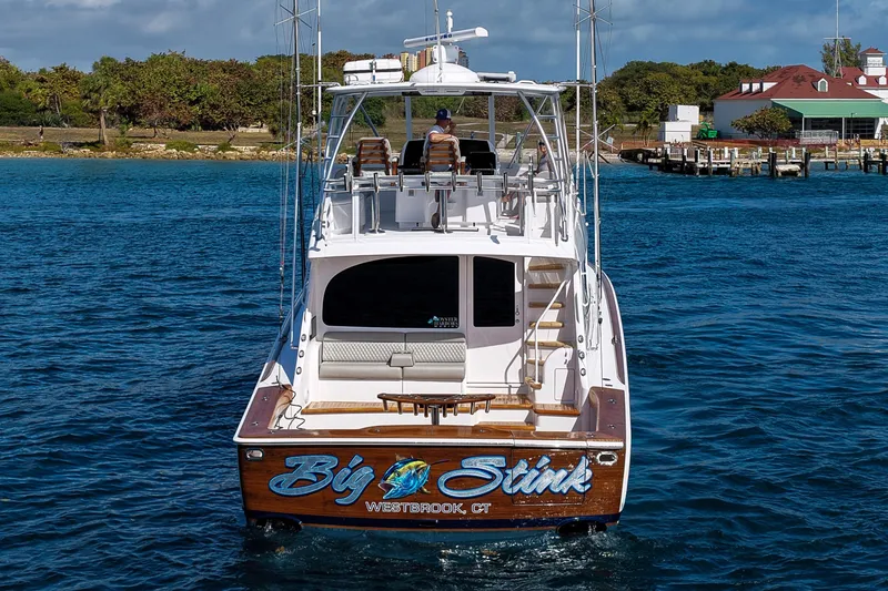 Slide: The Image of 2026 Viking 54 Convertible yacht on water, rear view, named "Big Stink," Westbrook, CT. - 2