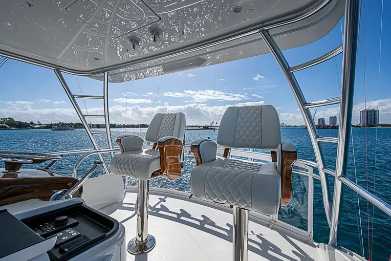 Slide: The Image of Luxury seating on 2026 Viking 54 Convertible yacht, overlooking serene ocean view. - 20
