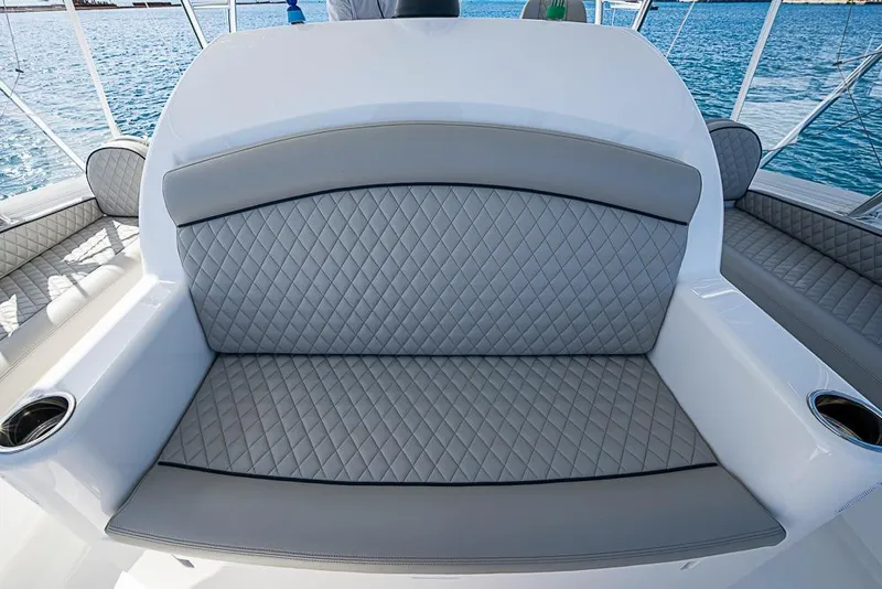 Slide: The Image of Luxurious seating on 2026 Viking 54 Convertible yacht with quilted upholstery and ocean backdrop. - 21