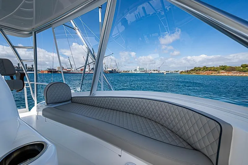 Slide: The Image of 2026 Viking 54 Convertible yacht interior with ocean view and luxurious seating. - 24