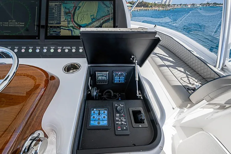 Slide: The Image of 2026 Viking 54 Convertible yacht helm with advanced navigation controls and ocean view. - 26