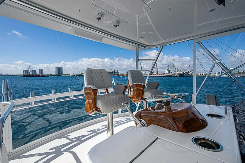 Slide: The Image of Luxurious 2026 Viking 54 Convertible yacht interior with ocean view and modern helm station. - 27