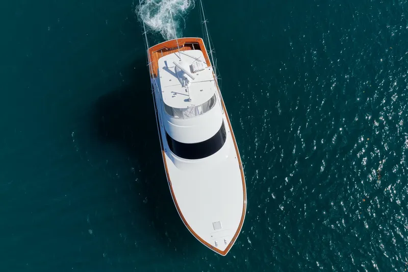 Slide: The Image of Aerial view of 2026 Viking 54 Convertible yacht cruising on blue ocean waters. - 3