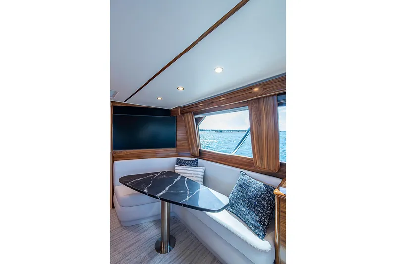Slide: The Image of Luxurious interior of 2026 Viking 54 Convertible yacht with elegant seating and ocean view. - 33