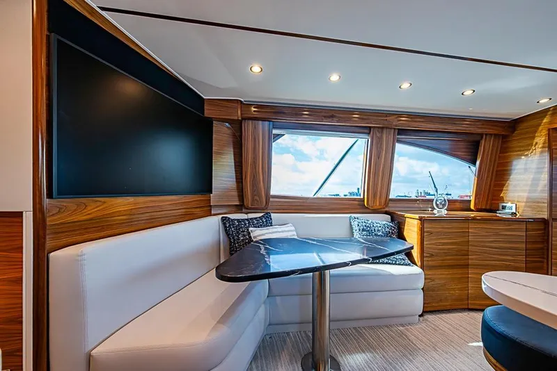 Slide: The Image of Luxurious interior of 2026 Viking 54 Convertible yacht with elegant seating and large windows. - 34