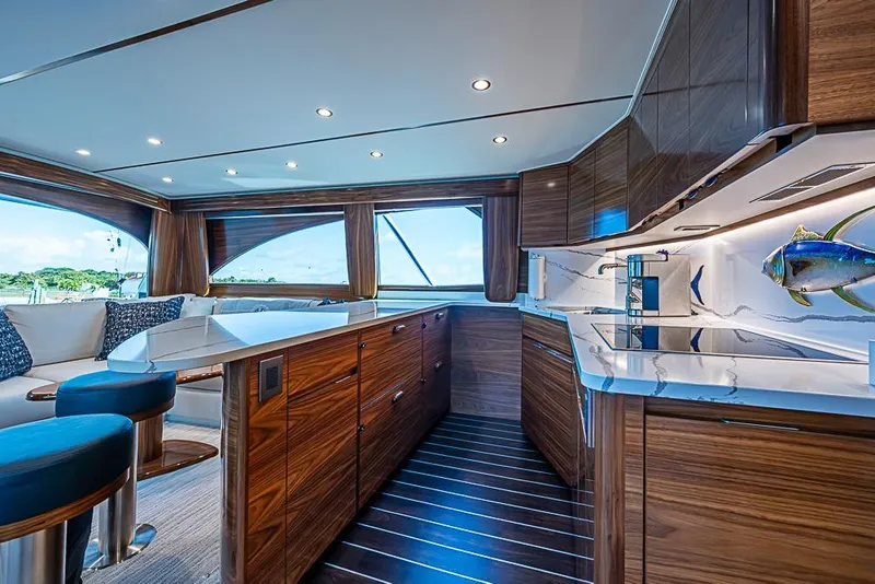 Slide: The Image of Luxurious interior of 2026 Viking 54 Convertible yacht with modern kitchen and seating area. - 36