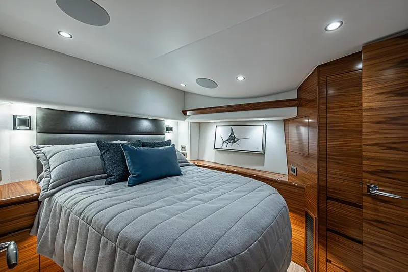 Slide: The Image of Luxurious bedroom interior of 2026 Viking 54 Convertible yacht with modern design and wood accents. - 39