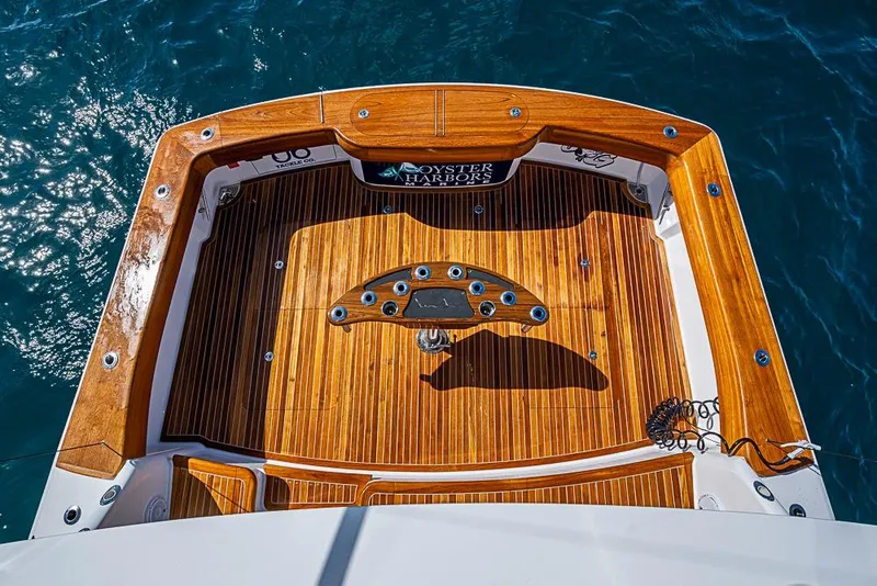 Slide: The Image of 2026 Viking 54 Convertible yacht deck with polished wood finish, viewed from above. - 4
