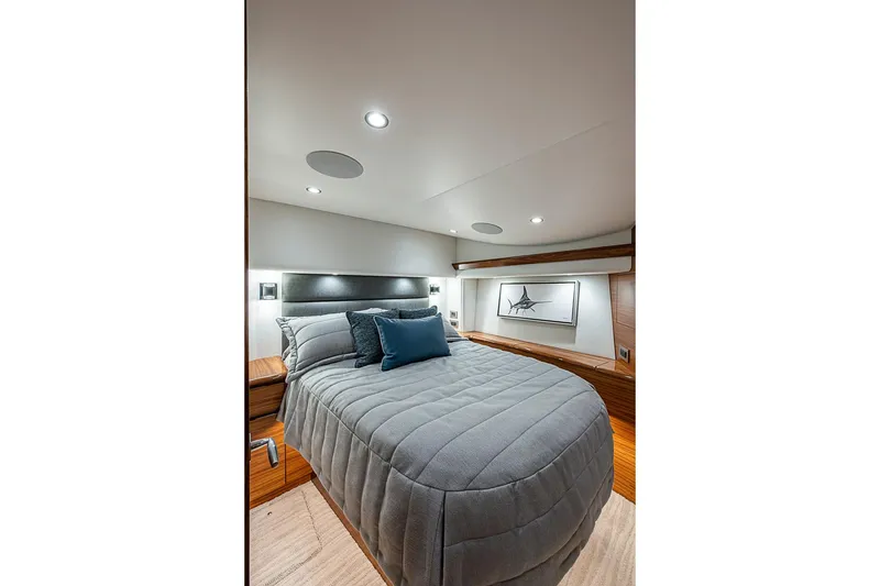 Slide: The Image of Luxurious bedroom interior of 2026 Viking 54 Convertible yacht with modern design and cozy bedding. - 40