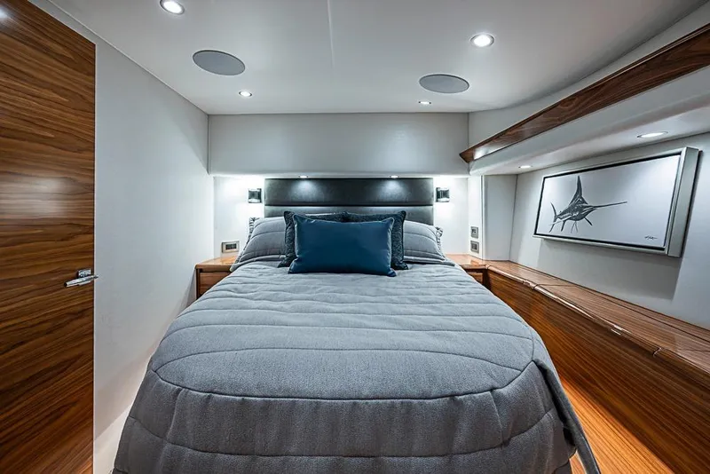 Slide: The Image of Luxurious bedroom interior of 2026 Viking 54 Convertible yacht with modern design and elegant wood finishes. - 41