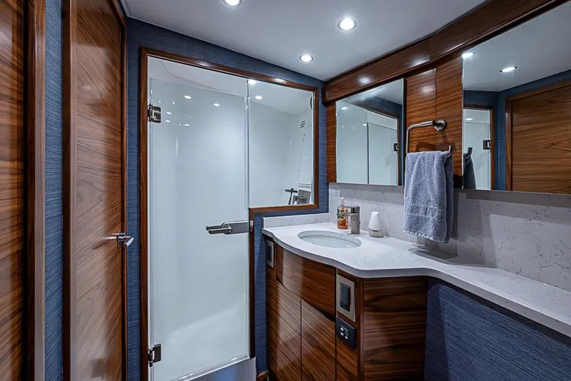 Slide: The Image of Luxurious bathroom in 2026 Viking 54 Convertible yacht with modern fixtures and wood accents. - 43