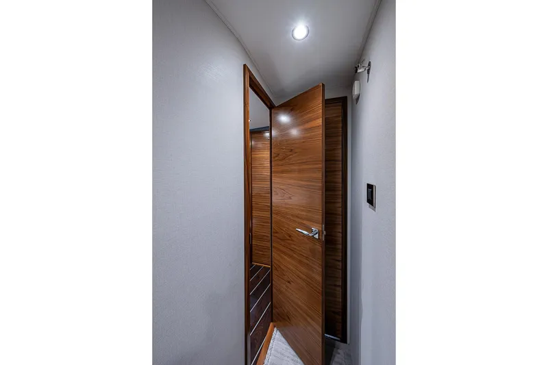 Slide: The Image of Interior hallway of 2026 Viking 54 Convertible yacht with wooden door. - 46