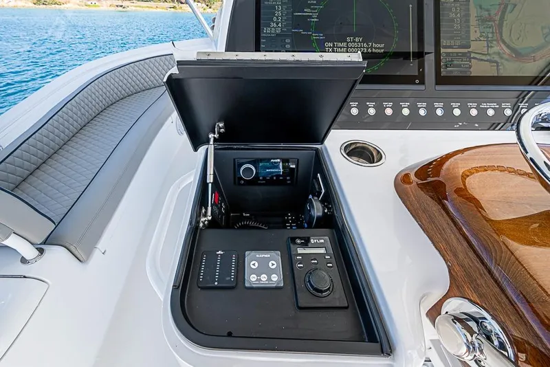 Slide: The Image of 2026 Viking 54 Convertible yacht dashboard with advanced navigation controls and seating. - 25