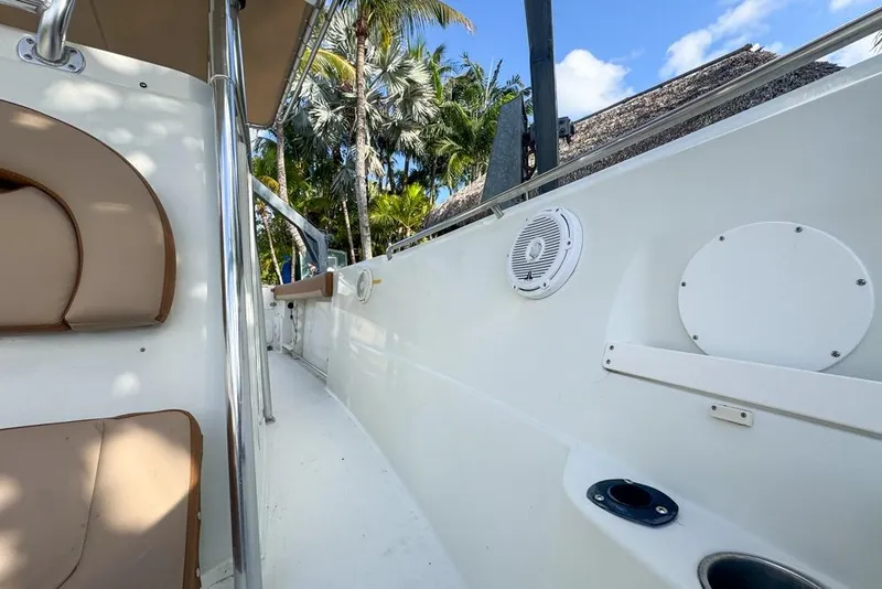 Slide: The Image of 2005 Sailfish 2660 CC boat interior with seating, speaker, and tropical background. - 13