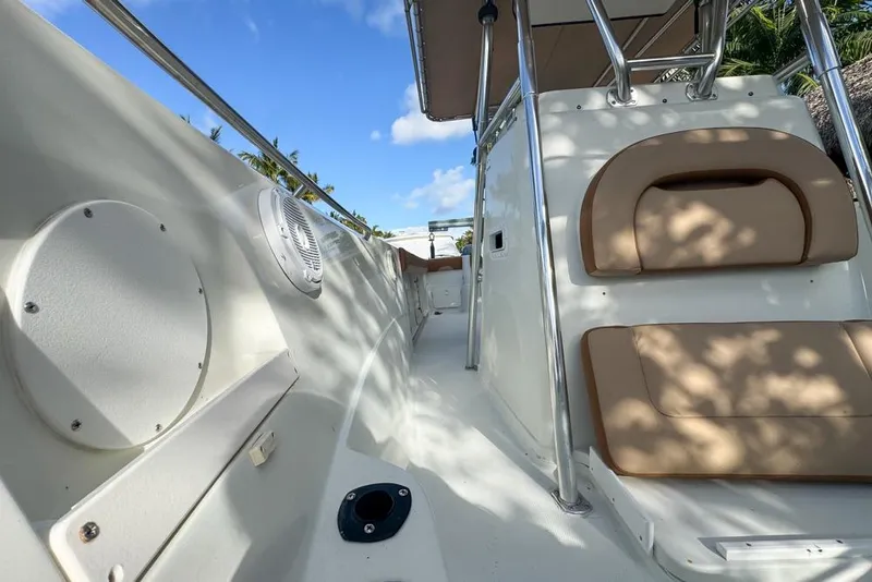 Slide: The Image of 2005 Sailfish 2660 CC boat interior with cushioned seating and stainless steel railings. - 14