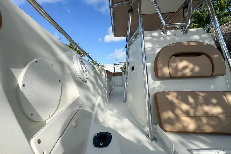 Slide: The Image of 2005 Sailfish 2660 CC boat interior with seating and railing under blue sky. - 15