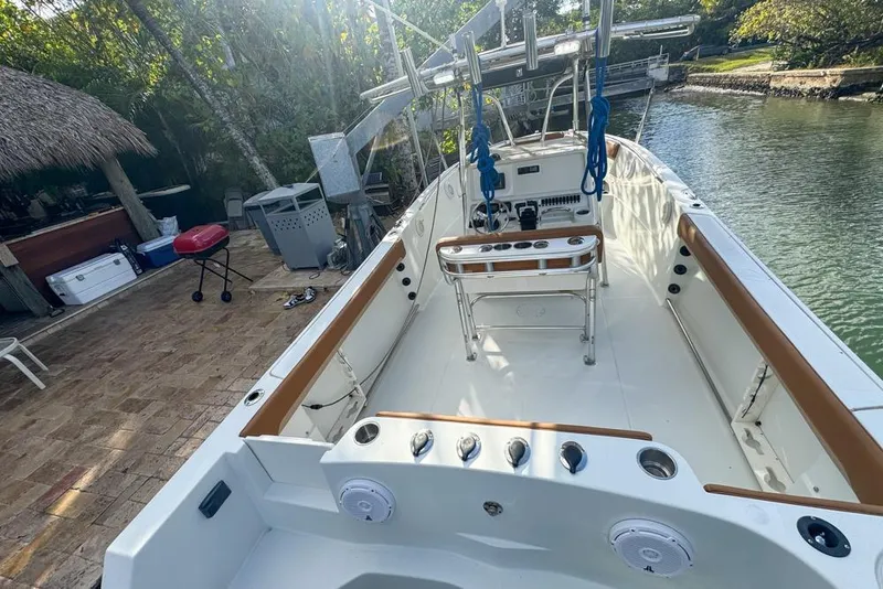 Slide: The Image of 2005 Sailfish 2660 CC boat docked by a patio with outdoor equipment. - 17