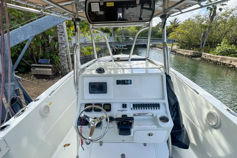 Slide: The Image of 2005 Sailfish 2660 CC boat interior with steering wheel and control panel. - 25