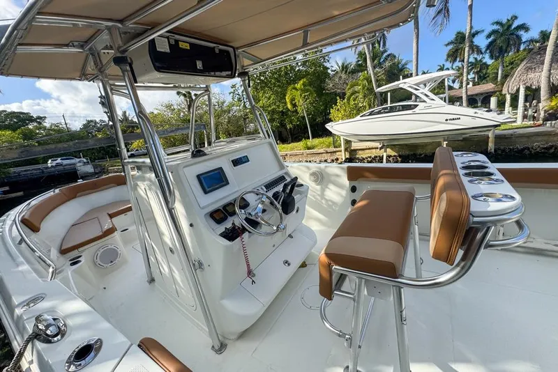 Slide: The Image of 2005 Sailfish 2660 CC boat interior with helm, seating, and tropical background. - 26