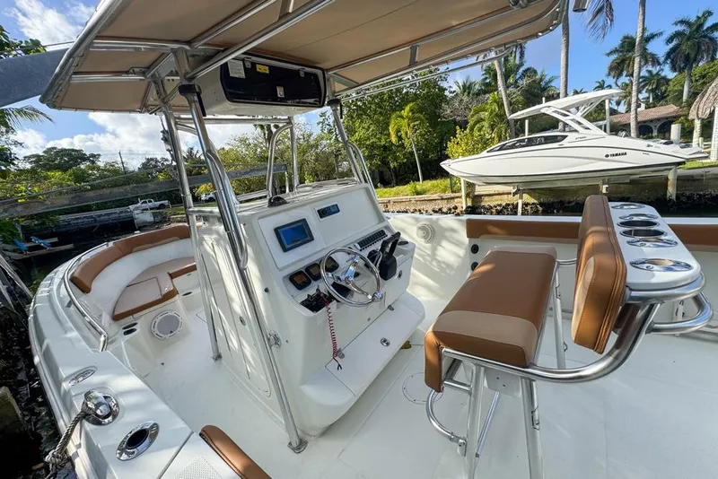 Slide: The Image of 2005 Sailfish 2660 CC boat interior with helm, seating, and tropical background. - 27