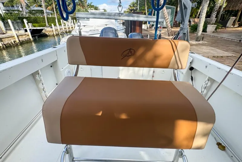 Slide: The Image of 2005 Sailfish 2660 CC boat with tan seating, docked by a canal. - 33