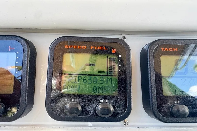 Slide: The Image of Dashboard of a 2005 Sailfish 2660 CC boat showing speed and fuel gauges. - 39
