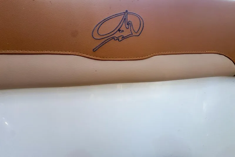 Slide: The Image of Brown and beige leather upholstery with embroidered logo on a 2005 Sailfish 2660 CC boat. - 43