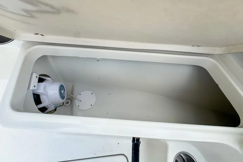Slide: The Image of Open storage compartment on 2005 Sailfish 2660 CC boat with speaker inside. - 45