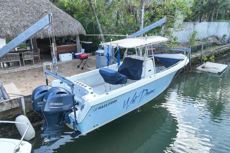 Slide: The Image of 2005 Sailfish 2660 CC boat docked with twin Yamaha engines, tropical setting. - 7