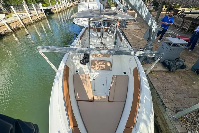 Slide: The Image of 2005 Sailfish 2660 CC boat docked, featuring spacious seating and sleek design. - 9